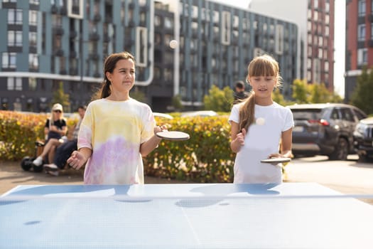 Photography of table tennis area in the public park. Street ping-pong sports competitions in spring day. Lifestyles of big city. People playing taBle tennis actively. High quality photo