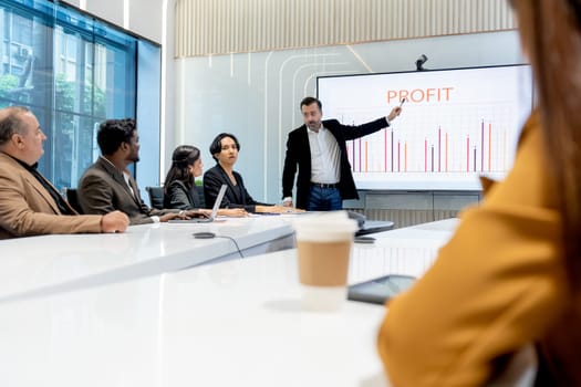 Side view of business manager man present and explain about the progress of the project to his colleagues or staffs in conference or meeting room.