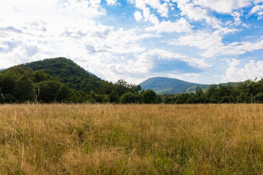 Beautiful landscape of small city and beautiful hills and mountains next to it at sunny day