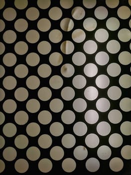 White circles with glowing light on ceiling inside old elevator