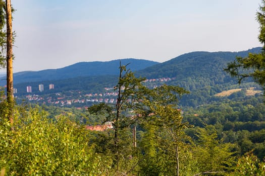 Beautiful landscape of small city and beautiful hills and mountains next to it at sunny day