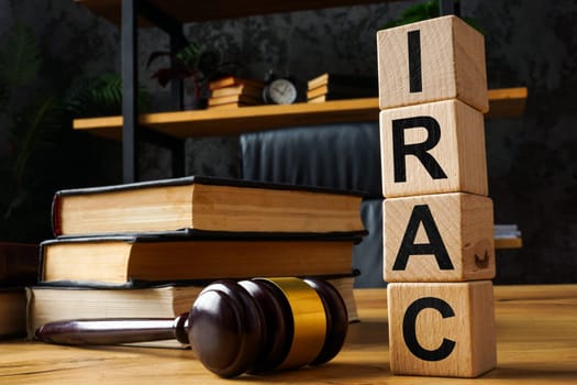 Gavel and wooden cubes with abbreviation IRAC Issue Rule Analysis Conclusion.