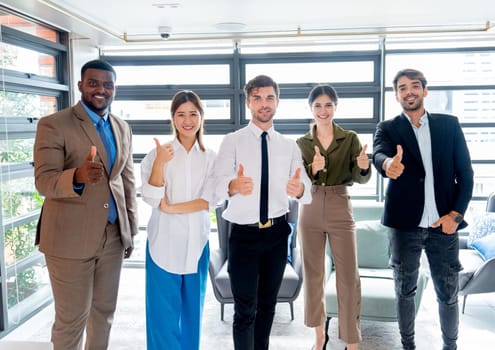 Portrait group of multiethnic business men and women stand in the office and show thumbs up to the camera with smiling.