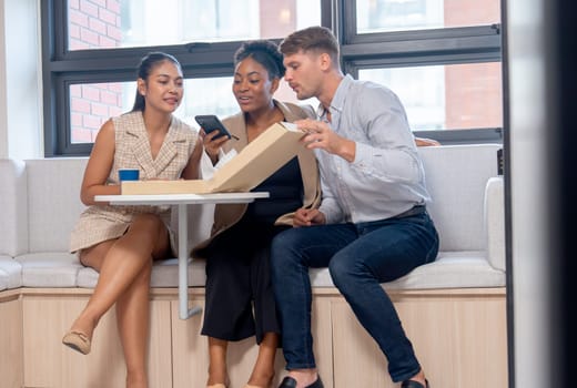 Business man and women express happiness together with pizza party during break or lunch time in office and woman also take the picture to share in social media.