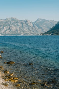 High mountain range in a light haze at the foot of the sea. High quality photo