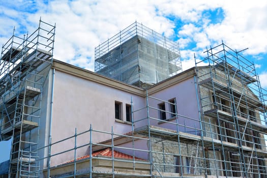 Iron construction scaffolding. Building facade white black photo