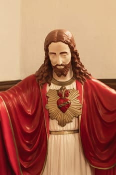 Statue of Jesus with a red heart white background