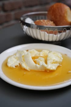 butter cream and honey in a bowl on table