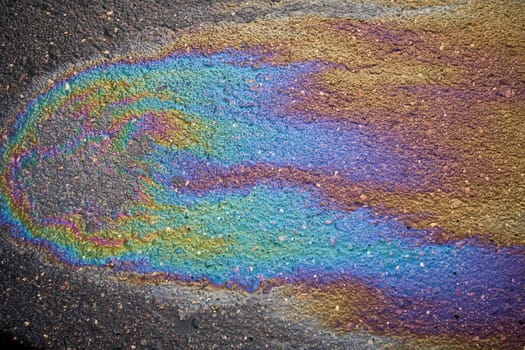 Fuel or oil stain on an asphalt road as a texture or background.