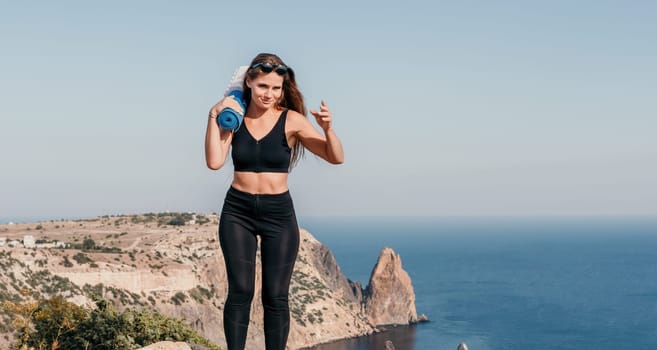 Fitness woman sea. Outdoor workout on yoga mat in park near to ocean beach. Female fitness pilates yoga routine concept. Healthy lifestyle. Happy fit woman exercising with rubber band in park.