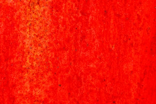 Red metal surface with spots creating textured wall background