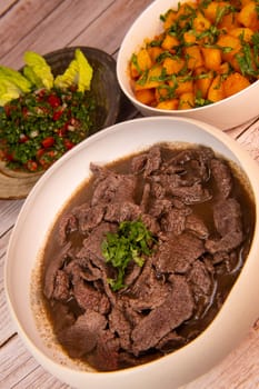 LEBANESE RECIPE, SHAWARMA, SPICY BEEF AND POTATOES, BATTATA HARA, GARLIC, CORIANDER AND PAPRIKA AND PLATE OF TABOULEH, High quality photo