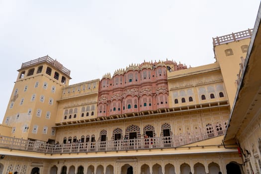 Jaipur, India - December 11, 2019: People at the beautiful Hawa Mahal, Palace of Winds in the pink city.
