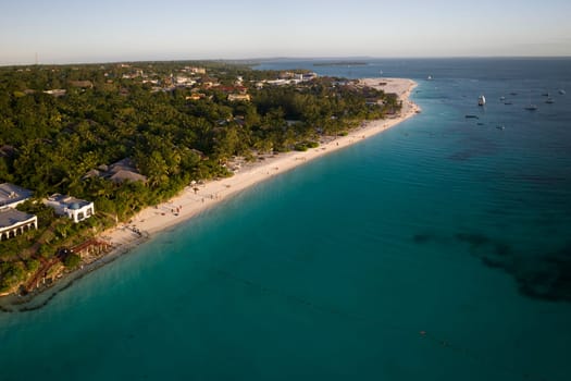 Amazing aerial view of shoreline and turquoise ocean in zanzibar at sunny day, tanzania.