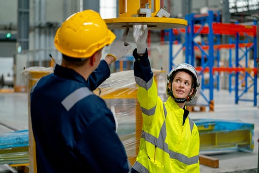 Technician man check part of machine with factory worker woman who touch the machine and they try to fix the problem in workplace area.