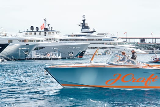 Monaco, Monte Carlo, 29 September 2022 - Water taxi by luxury motorboat on the famous yacht exhibition, a lot of most expensive luxury yachts, richest people, yacht brokers, boat traffic. High quality photo