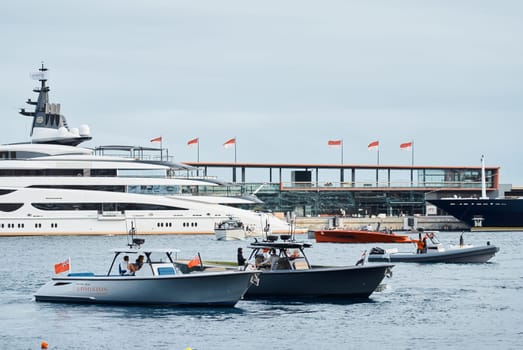 Monaco, Monte Carlo, 29 September 2022 - Water taxi by luxury motorboat on the famous yacht exhibition, a lot of most expensive luxury yachts, richest people, yacht brokers, boat traffic. High quality photo