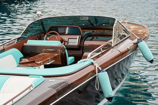 Interior of the luxury motor boat, port of Hercules in Monaco, sunny glare of the sun on the water, powerful boat, glossy surfaces shine in sunny weather. High quality photo