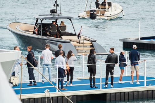 Monaco, Monte Carlo, 29 September 2022 - Water taxi by luxury motorboat on the famous yacht exhibition, a lot of most expensive luxury yachts, richest people, yacht brokers, boat traffic. High quality photo