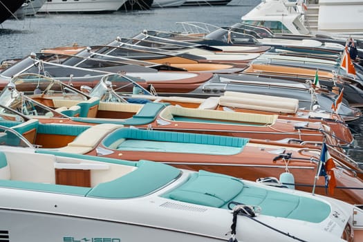 Monaco, Monte Carlo, 29 September 2022 - Few luxury retro motorboats Riva in a row at the famous motorboat exhibition in the principality, elegance boats for rich clients. High quality photo