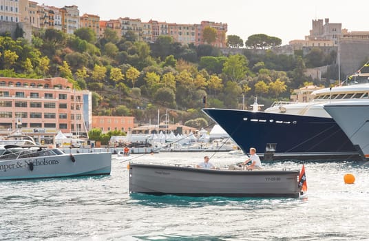 Monaco, Monte Carlo, 29 September 2022 - Water taxi by luxury motorboat on the famous yacht exhibition, a lot of most expensive luxury yachts, richest people, yacht brokers, boat traffic. High quality photo