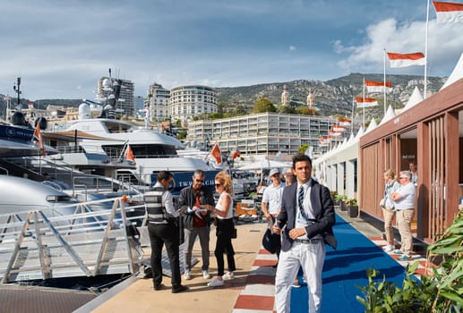 Monaco, Monte Carlo, 29 September 2022 - a lot of people, clients and yacht brokers look at the mega yachts presented, discuss the novelties of the boating industry at the famous motorboat exhibition. High quality photo