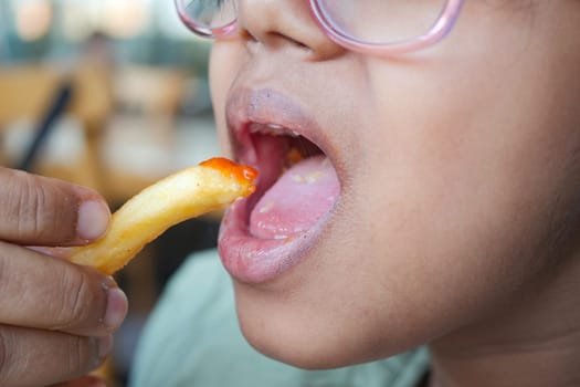 child eating french fries close up ,