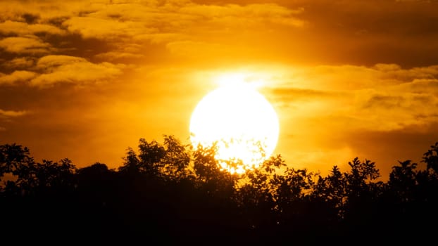 Beautiful nature morning with orange, yellow sunshine and fluffy clouds. Beautiful colorful dramatic sky with clouds at sunset or sunrise.