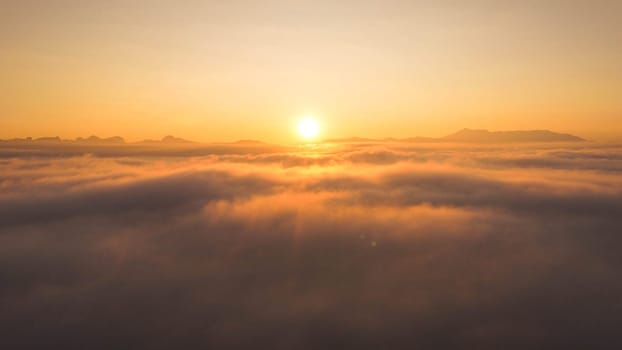 Beautiful nature morning with orange, yellow sunshine and fluffy clouds. Beautiful colorful dramatic sky with clouds at sunset or sunrise.