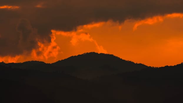 Beautiful nature morning with orange, yellow sunshine and fluffy clouds. Beautiful colorful dramatic sky with clouds at sunset or sunrise.