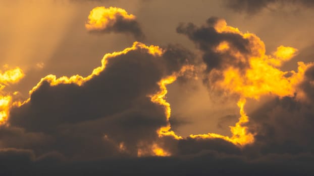 Beautiful nature morning with orange, yellow sunshine and fluffy clouds. Beautiful colorful dramatic sky with clouds at sunset or sunrise.