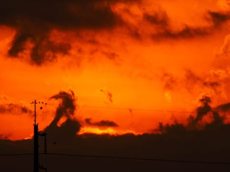 Beautiful nature morning with orange, yellow sunshine and fluffy clouds. Time lapse of a beautiful dramatic sky with a big sun at sunrise.