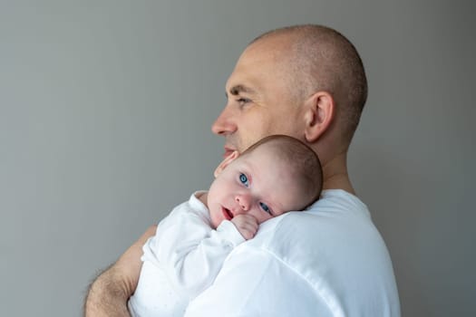 Little baby on father's shoulder. Parental care concept