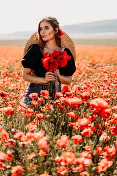 Woman poppies field. portrait of a happy woman with long hair in a poppy field and enjoying the beauty of nature in a warm summer day