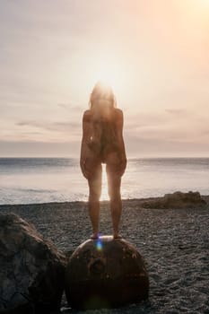 Woman travel sea. Young Happy woman in a long red dress posing on a beach near the sea on background of volcanic rocks, like in Iceland, sharing travel adventure journey