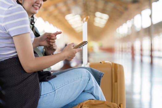 Woman using mobile phone while travel by train. travel concept.