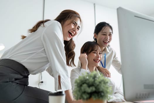 Group of people working together on a project in a startup company office.