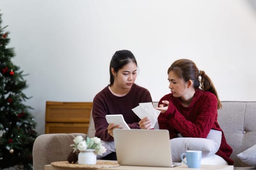 Stressful Accounting at Home, young family filling tax forms, mortgage documents, bills, checks, balances, invoices are in order.