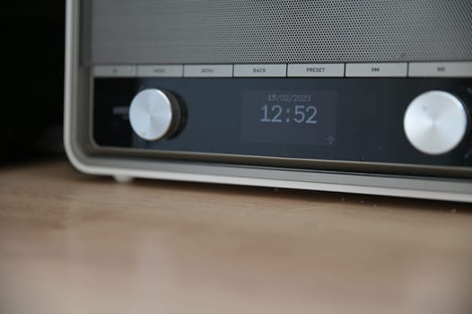 Beige retro kitchen radio with time on the LCD display