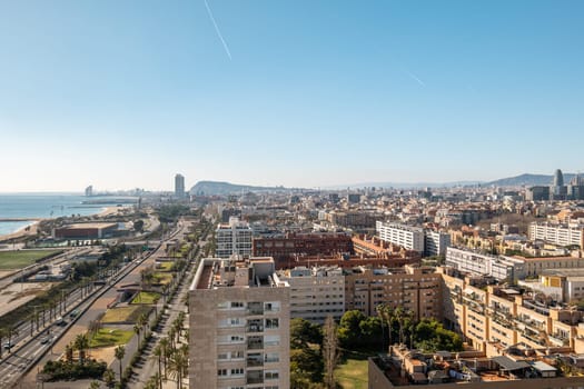 Barcelona city with highway and residential buildings stretching along waterfront and beaches. Atmospheric city for townspeople and tourists and travelers