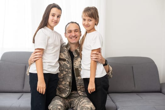 Little girl with her military father at home. High quality photo