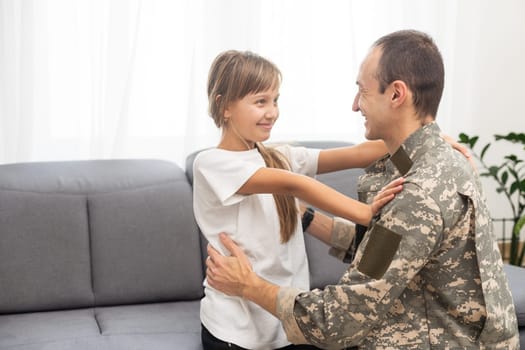 pretty little girl hugging her military father. High quality photo