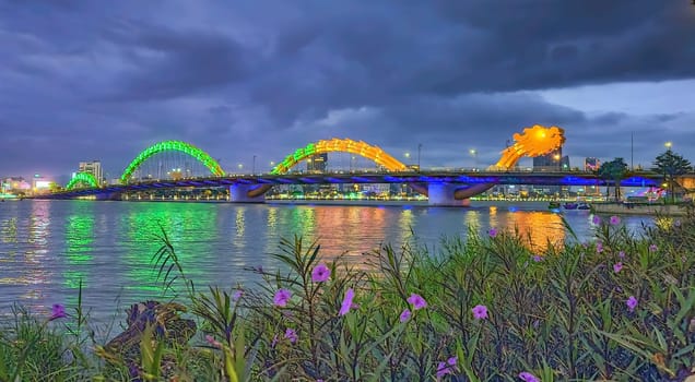 Famous colorful dragon bridge over river Han in Da Nang by night, Vietnam