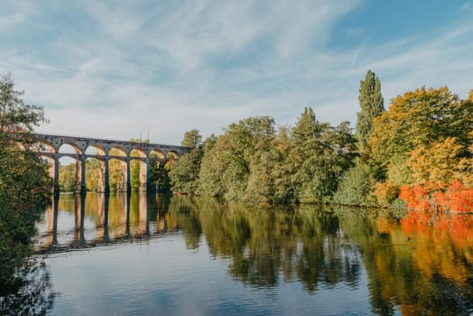 Railway Bridge with river in Bietigheim-Bissingen, Germany. Autumn. Railway viaduct over the Enz River, built in 1853 by Karl von Etzel on a sunny summer day. Bietigheim-Bissingen, Germany. Old viaduct in Bietigheim reflected in the river. Baden-Wurttemberg, Germany. Train passing a train bridge on a cloudy day in Germany