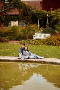 lovely young couple kissing outdoors in autumn. Loving couple walking in nature. Autumn mood. Happy man and woman hugging and kissing in autumn. Love. Fashionable couple outdoors. Fashion, people and lifestyle. Stylish couple in autumn outfit.