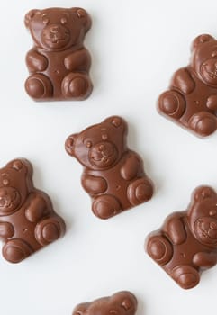Chocolate teddy bear on a white background. Charming chocolate and delicious gift