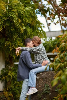 Joyful Autumn Embrace: Cute Lovers Strolling in the Park. Young Cute Female Hugs Boyfriend. In Autumn Outdoor. Lovers Walking in Park. Attractive Funny Couple. Lovestory in Forest. Man and Woman. Cute Lovers in the Park. Family Concept. Happy Couple.