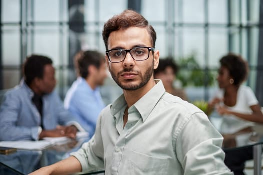 business man with executives working in background in office