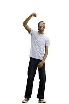 A man in a gray T-shirt, on a white background, in full height, rejoices.