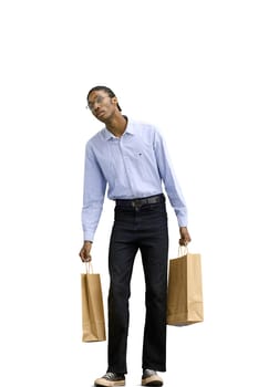 A man in a gray shirt, on a white background, full-length, with bags.